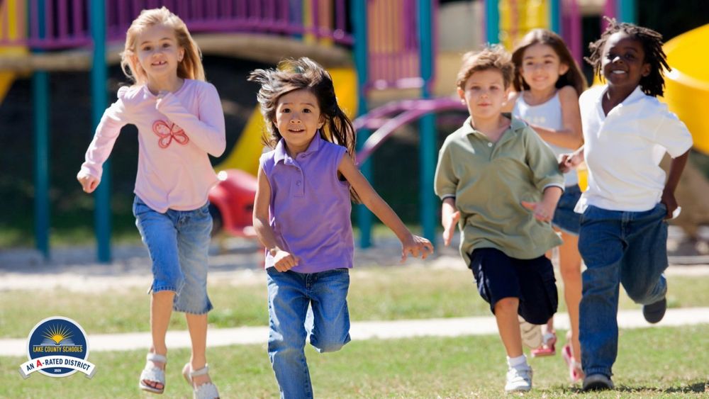 Stock image of five elementary age children running on a playground