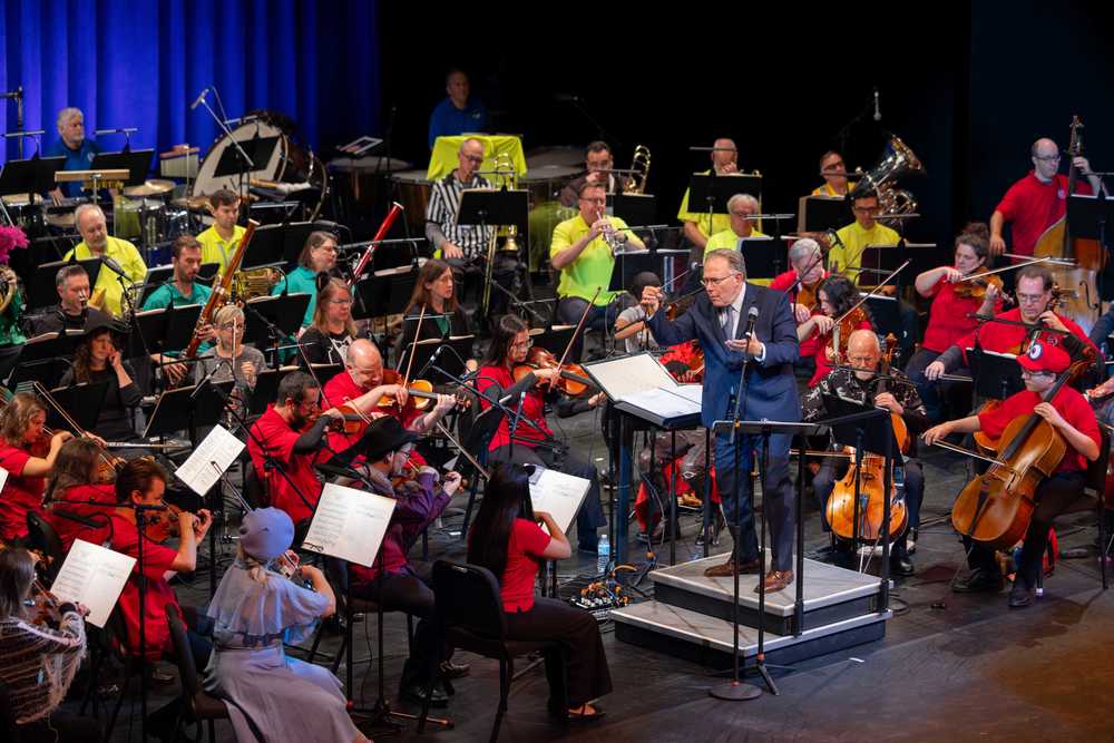 Orchestra playing dressed in colorful red, yellow and turquoise shirts