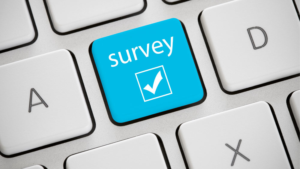 Computer keyboard wth a key highlighted in blue and marked "survey"