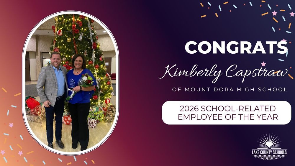 Kyle Bracewell and Kimberly Capstraw posed in front of Christmas tree. Wording: Congrats Kimberly Capstraw of Mount Dora High School, 2026 School-Related Employee of the Year