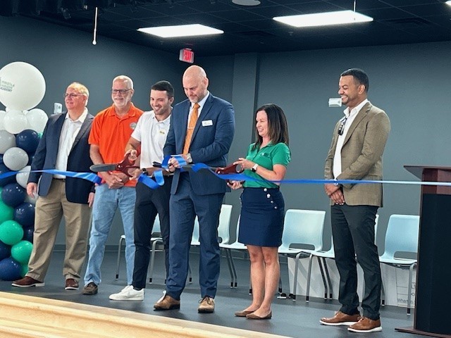 School board member Tyler Brandeburg, Deputy Superintendent Chad Farnsworth and prncipal Andrea Nelson stand with Minneola Mayor Kelly and representatives from Wharton-Smith Inc. to cut the ribbon at Minneola Horizon Academy