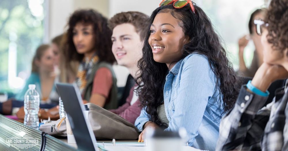 High school students in class with laptops and bottles of water