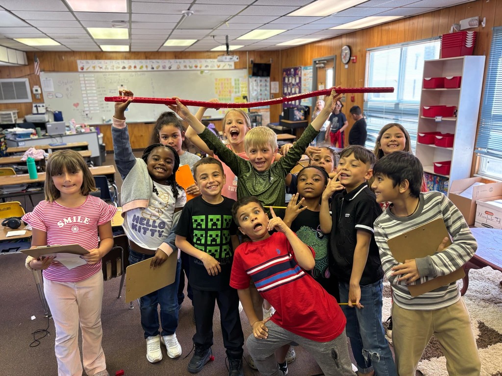 A group of students posing for a photo in class