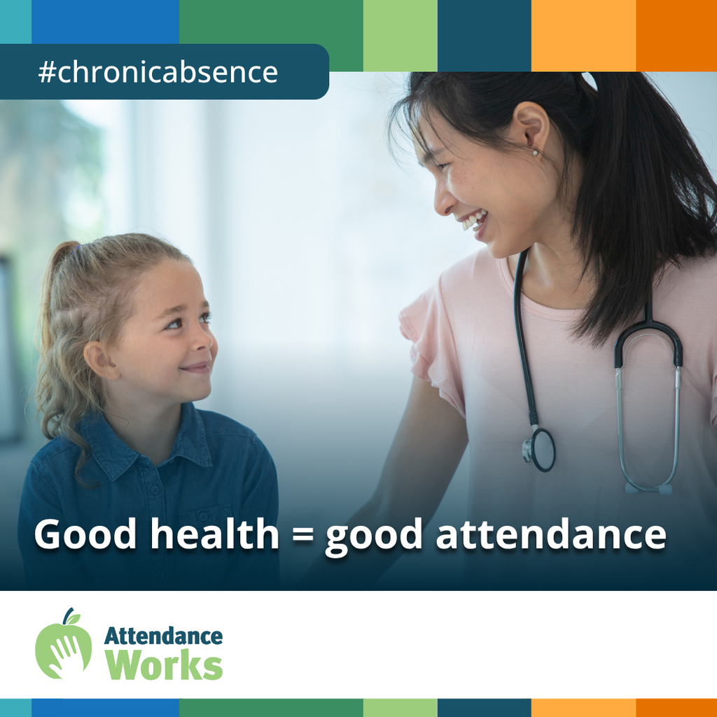 Young girl smiling at female doctor who is wearing a stethoscope.