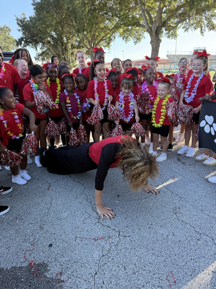 Cheerleaders encouraged Mrs. Werner to do some push-ups.