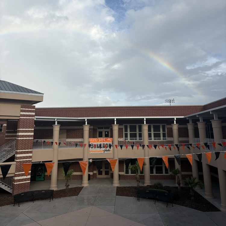a rainbow breaks through the clouds as UHS SGA puts finishing touches on campus decorations