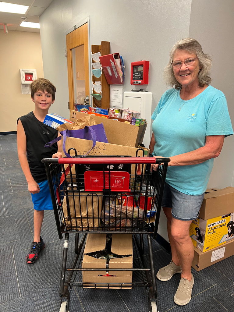 CompassLife Church with a shopping cart full of food donations for Thanksgiving to go to needy Bullpups.