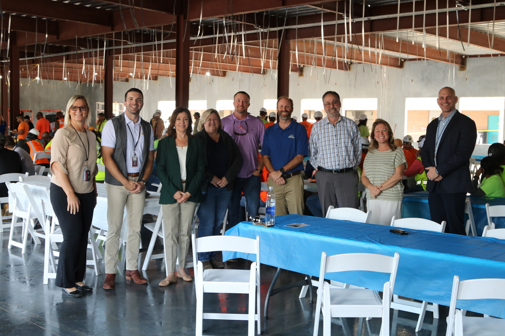 Senior staff and board members pose on site at Beverly Shores Elementary School