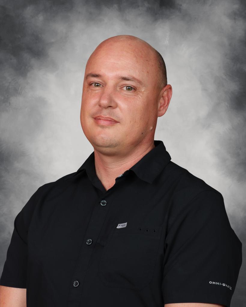 A teacher poses for an award.