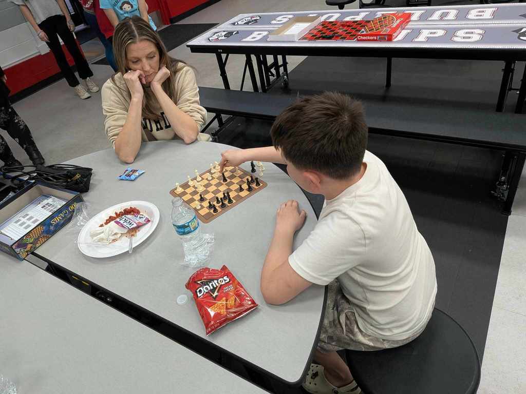 pictures of families gathered together playing board games and enjoying dinner provided by LifePointe Church in Eustis.