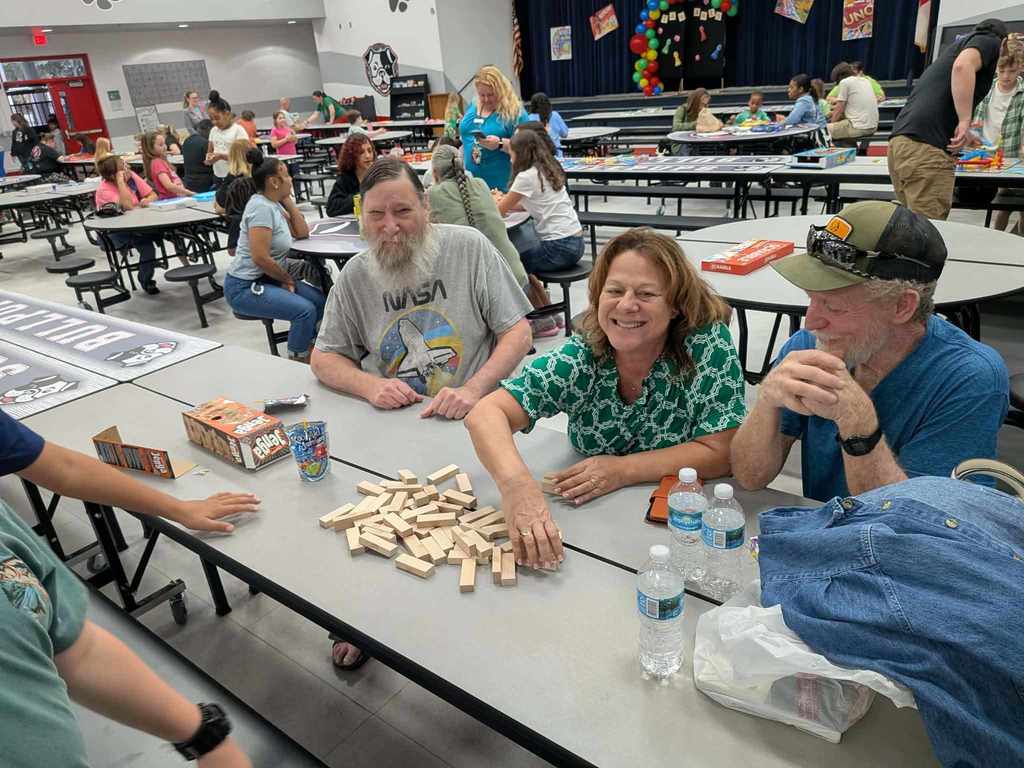 families enjoying a game of Jenga