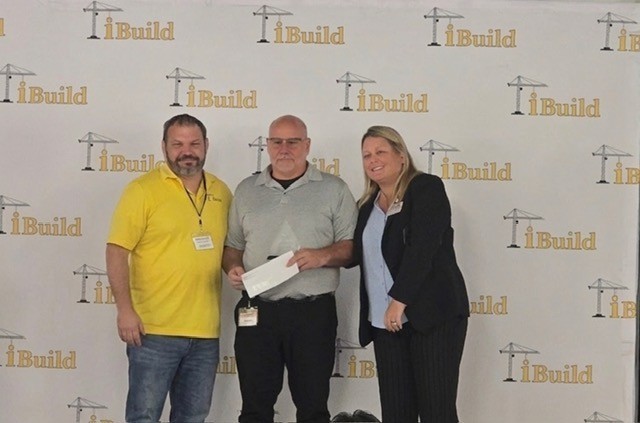 Dan Mccauly posted with two representatives from iBuild