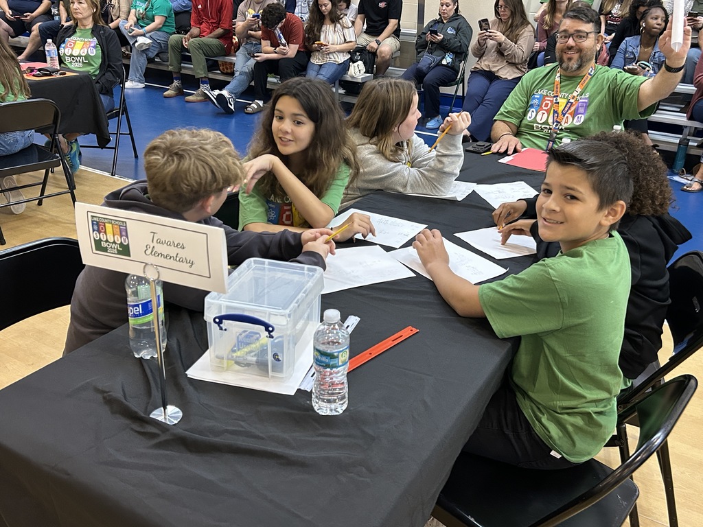 Tavares Elementary students conversing over worksheets