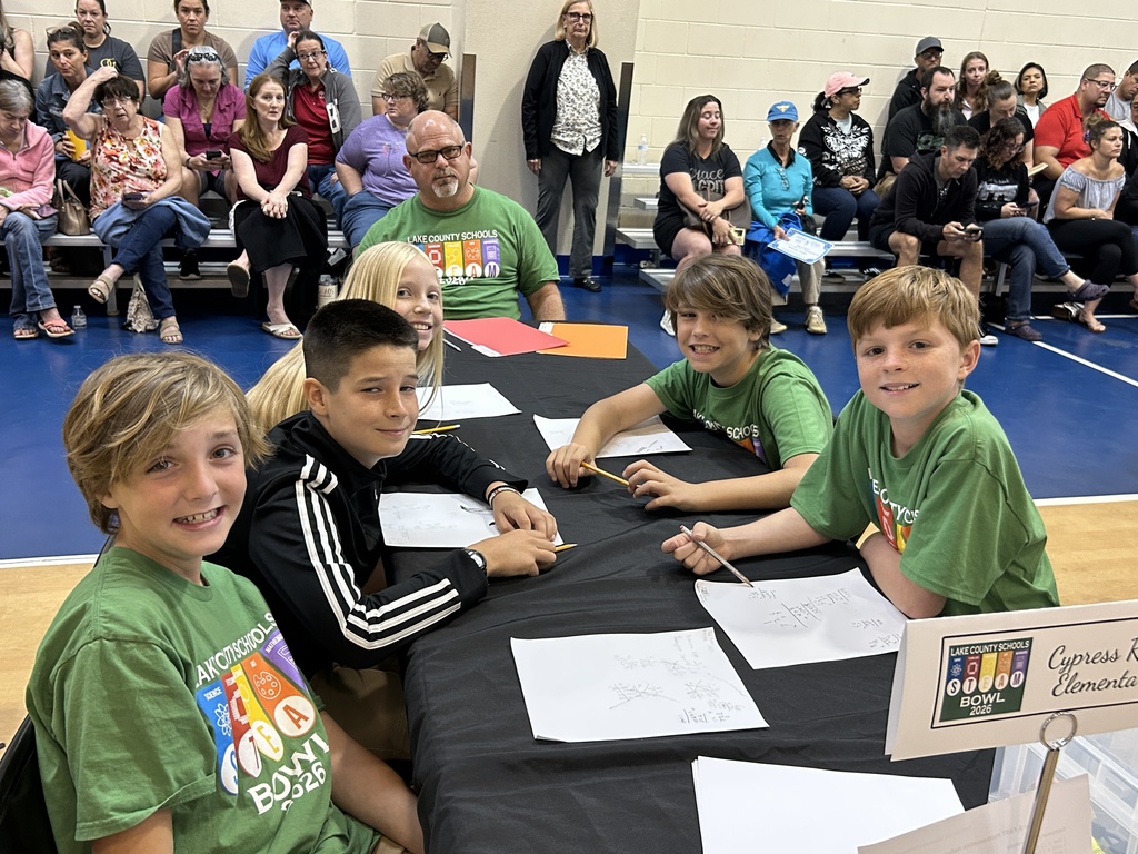 Cypress ridge elementary students and teacher posing at table. smiling for camera