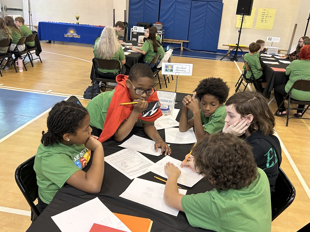 Groveland Elementary students conversing over worksheets