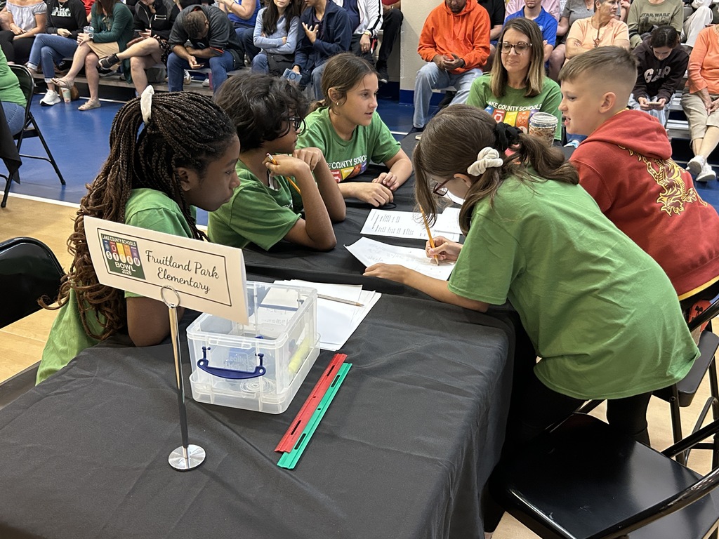 Fruitland park elementary students conversing over worksheets