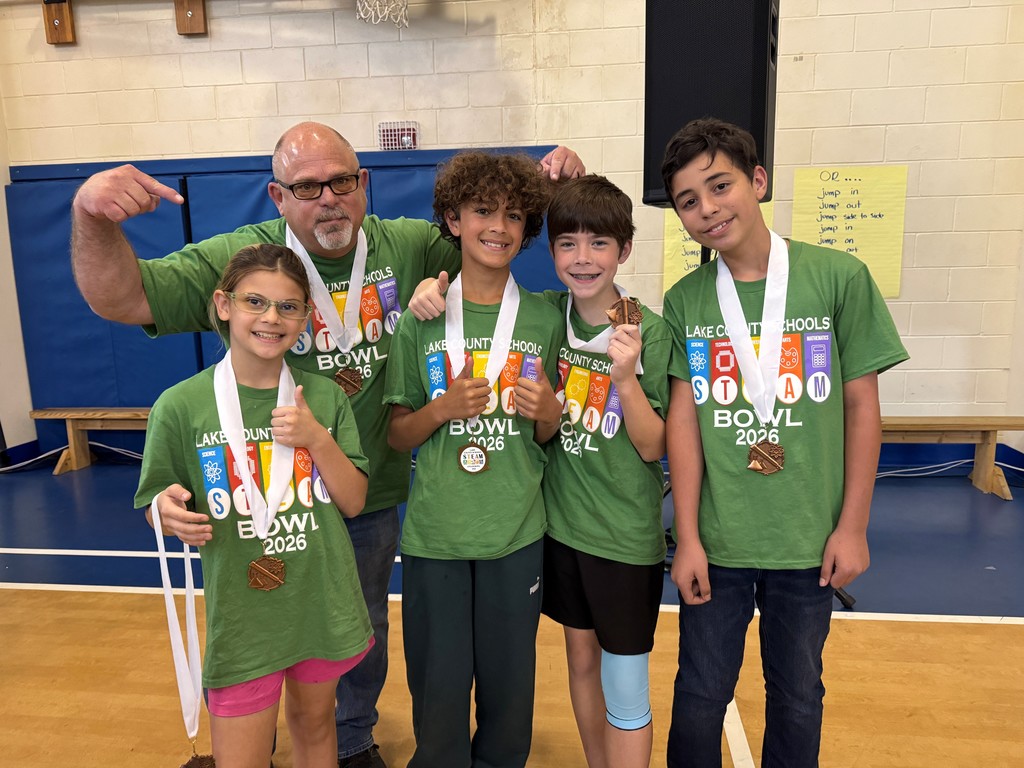 This is a photo of the Astatula Elementary STEAM team and their coach, Mr. Burris, wearing their 3rd place medals.