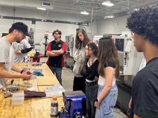 High school students taking a tour and watching a demonstration at Lake Technical College
