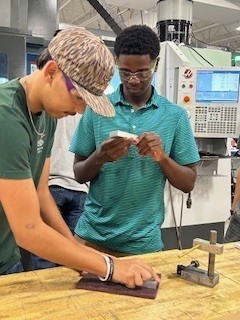 Student getting a hands-on manufacturing demonstration