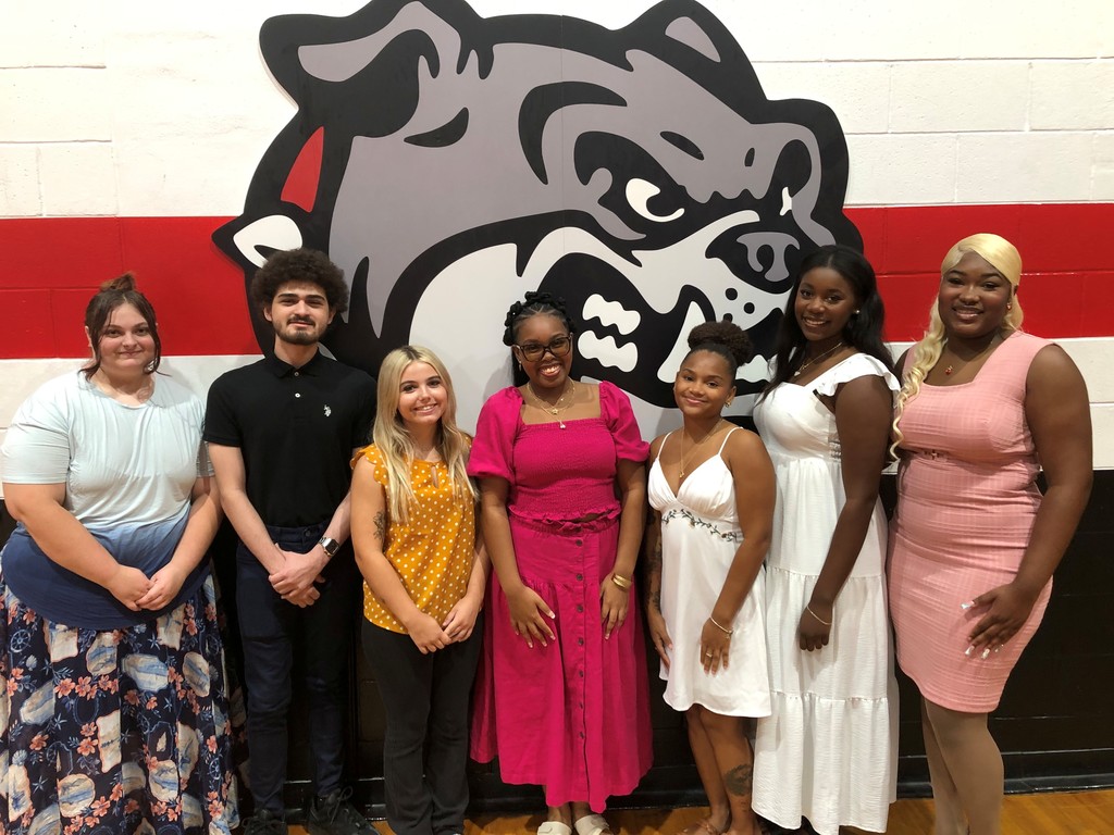 Seven students standing in front of Tavares High bulldog logo