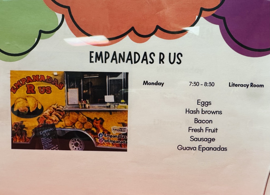 Yellow food truck parked outdoors with large illustrations of cooked empanadas on its side; a plate showing two empanadas with dipping sauce is visible. A chalkboard-style menu is partially seen on the truck’s side. Text on the truck reads “EMPANADAS R US.” Event details printed nearby note a breakfast service Monday 7:30–8:30 in the Literacy Room offering eggs, hash browns, bacon, fresh fruit, sausage, and guava empanadas. Social media handles for Empanadas are also displayed.