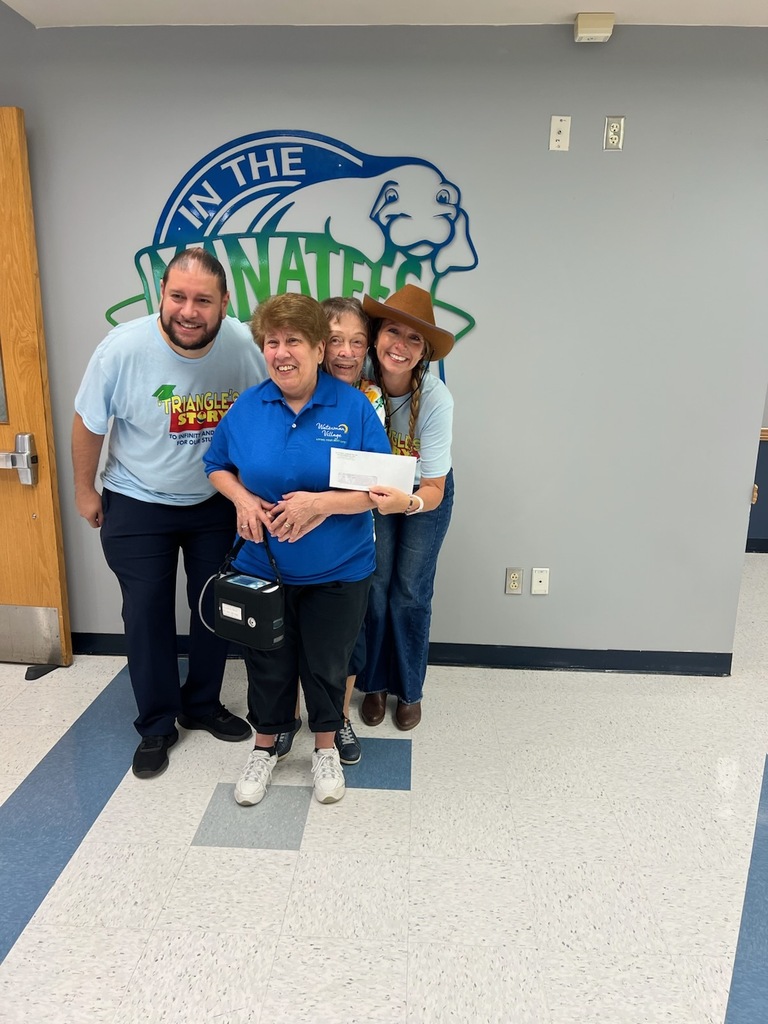 Waterman Village drops off check to support Triangle Elementary's Principal fund 