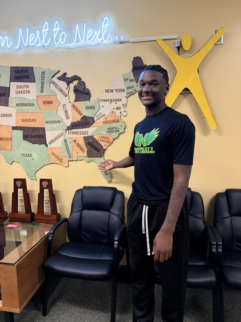 Person in black t-shirt and pants stands in front of a map of the US.