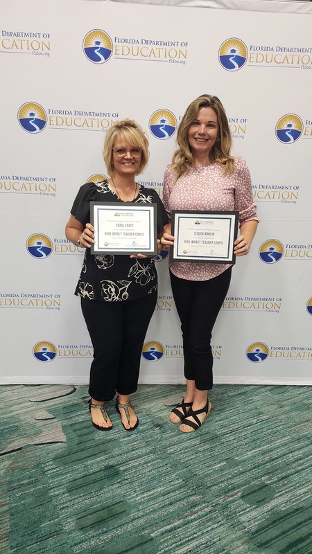 Carol Tracy and Jessica Noblin posed together and holding certificates.