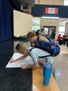 Students signing a kindness pledge