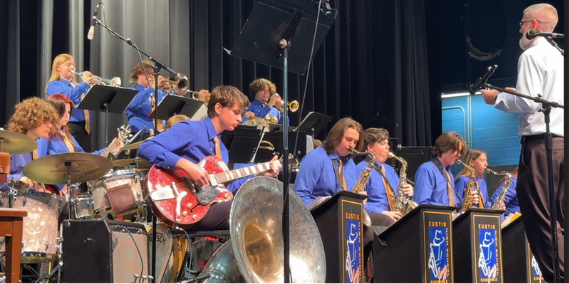 Band performing in matching blue shirts