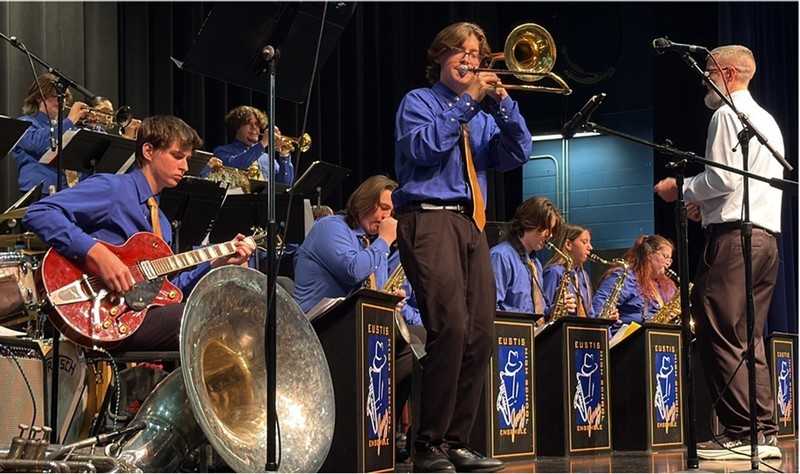 Band performing with trombonist standing in front