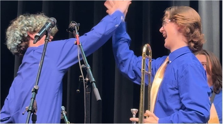 Two band members giving each other a high five