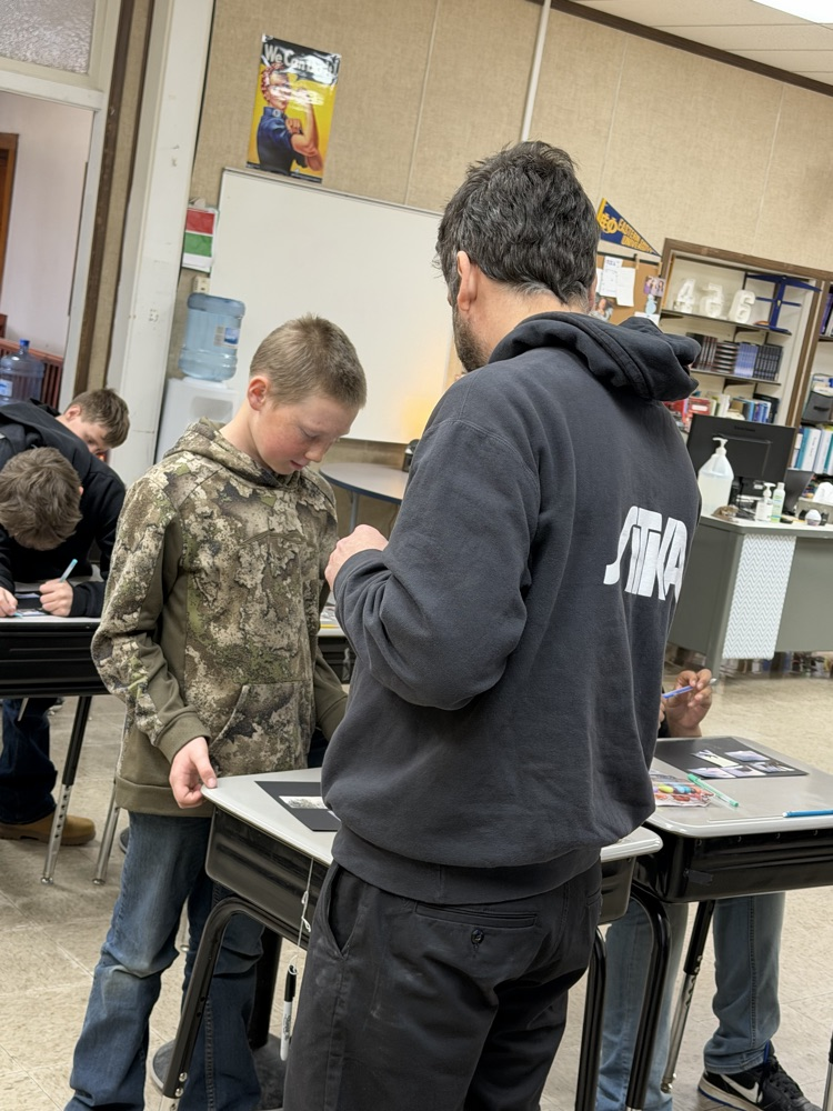 Sitka center employee helping student 