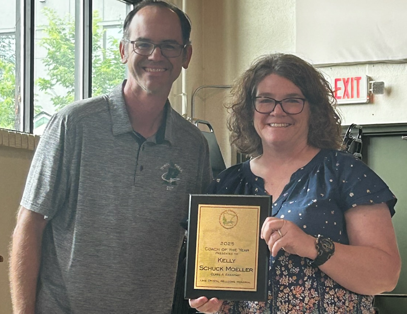 Kelly Moeller standing next to Rockford HS Cross Country Coaches Association President presenting the 2025 Minnesota State Assistant Cross Country Coach of the Year Award to Kelly Moeller at the Coaches Clinic on July 20 in Northfield, MN.
