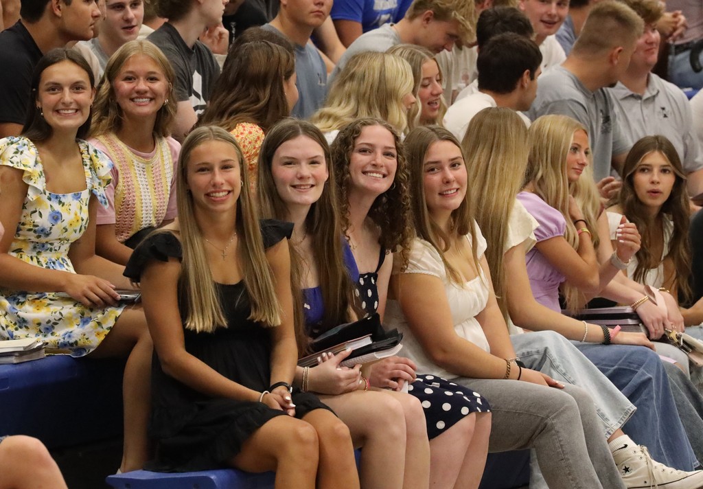 Students smiling on first day in the assembly