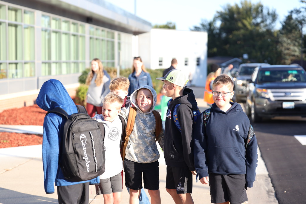 boys smiling in front of the school