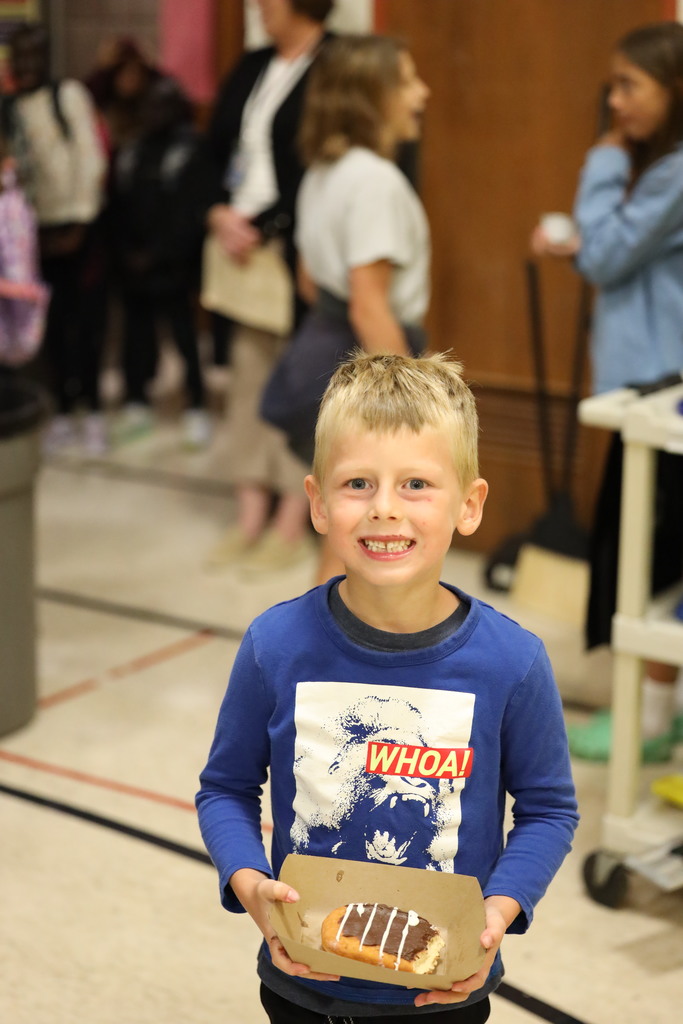 Little boy finishing up breakfast, smiling at camera