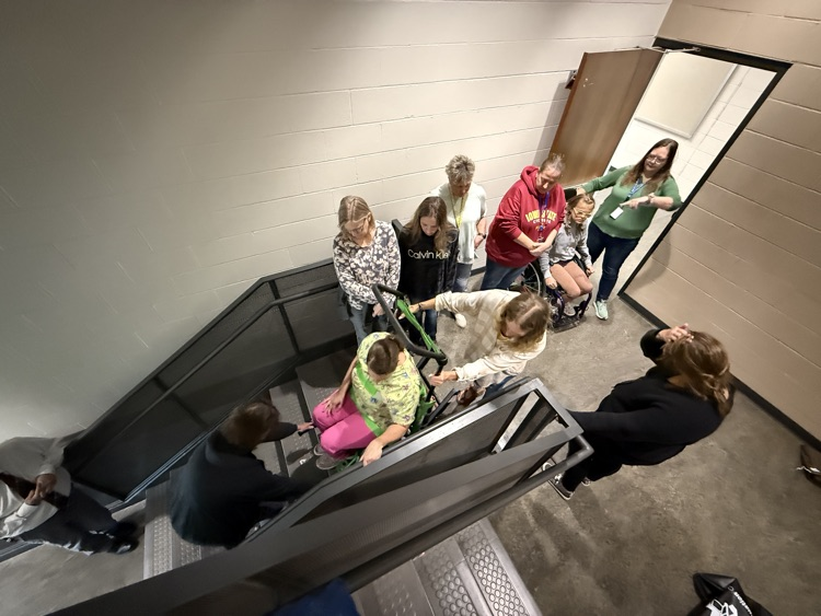 paras practicing using the striker evacuation wheelchair 