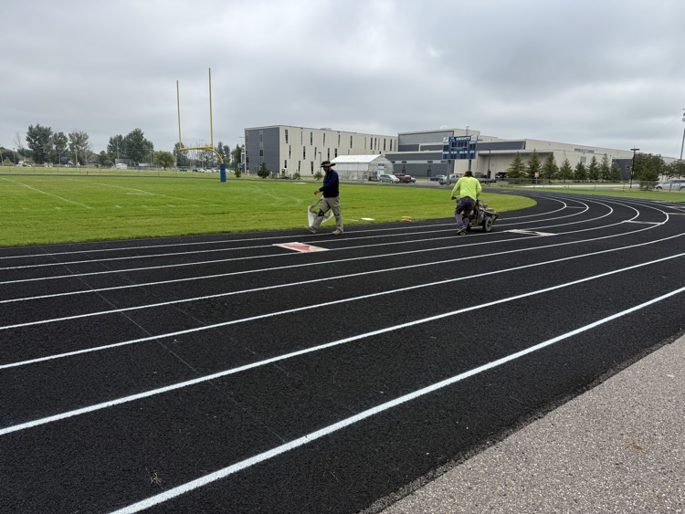 track workers putting stripes and marks on the track  