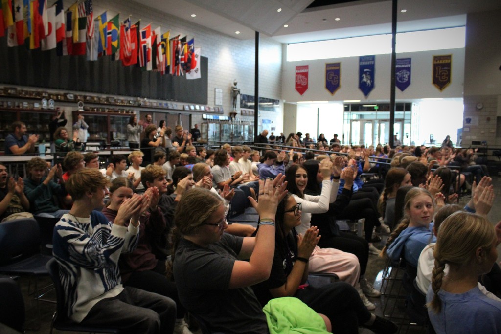 Students clapping along to one of his songs he played.