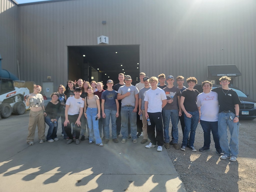 Tour of Manufacturing students posing in front of one of the businesses.