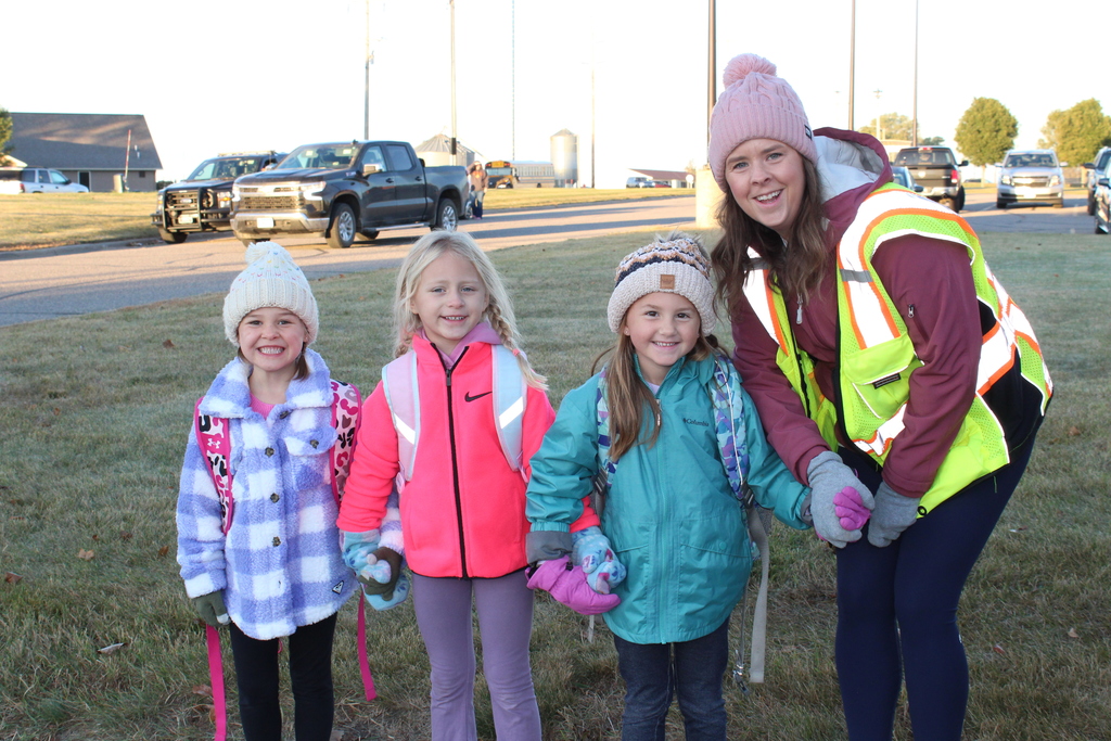students and teacher posing and smiling for the camera.