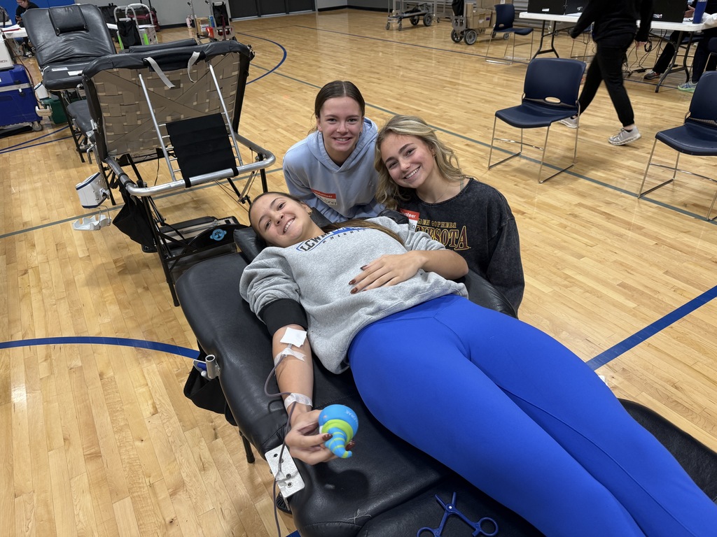 Student lying down on the chair donating blood.