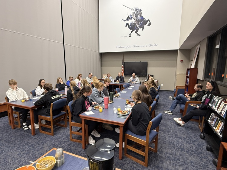student council members eating breakfast with school board members.