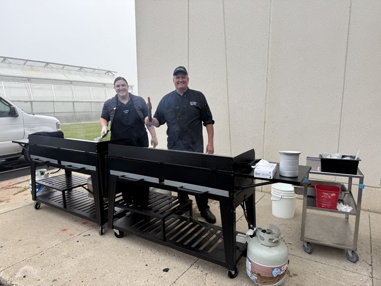 chef Tony and Amber grilling hot dogs and burgers earlier this fall