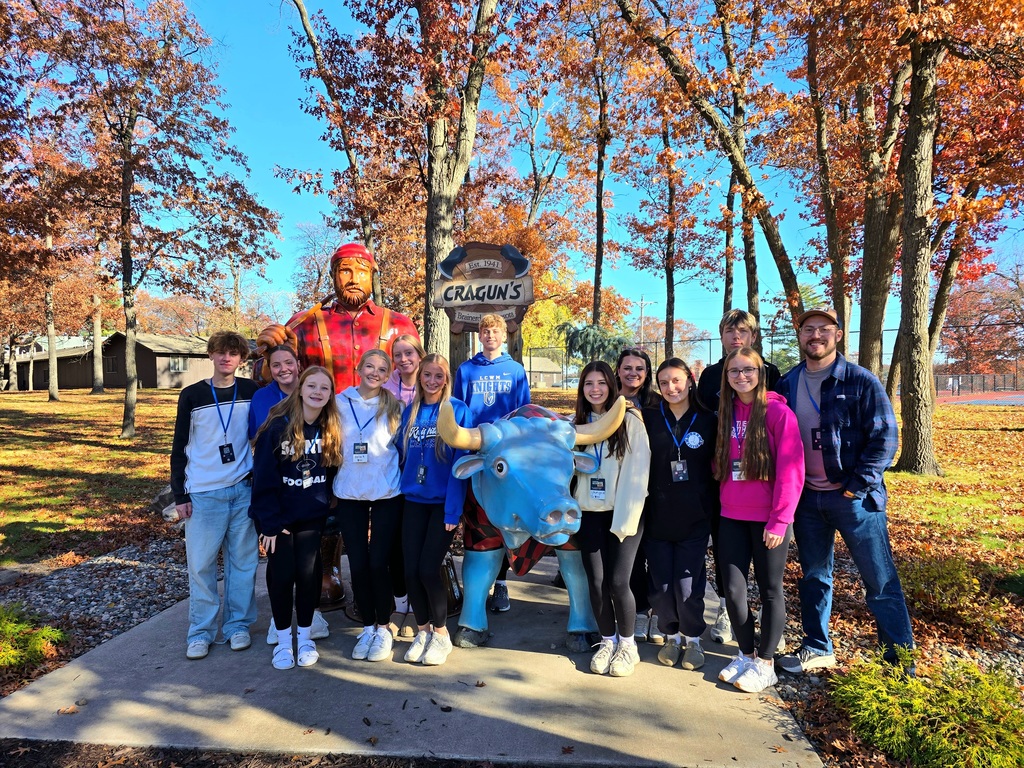 Students posing in front of Paul Bunyan and the Cragun's resort sign.