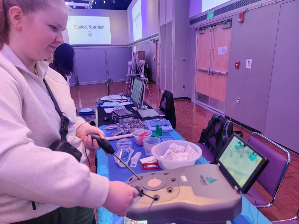 student using medical equipment in a virtual reality type setting.