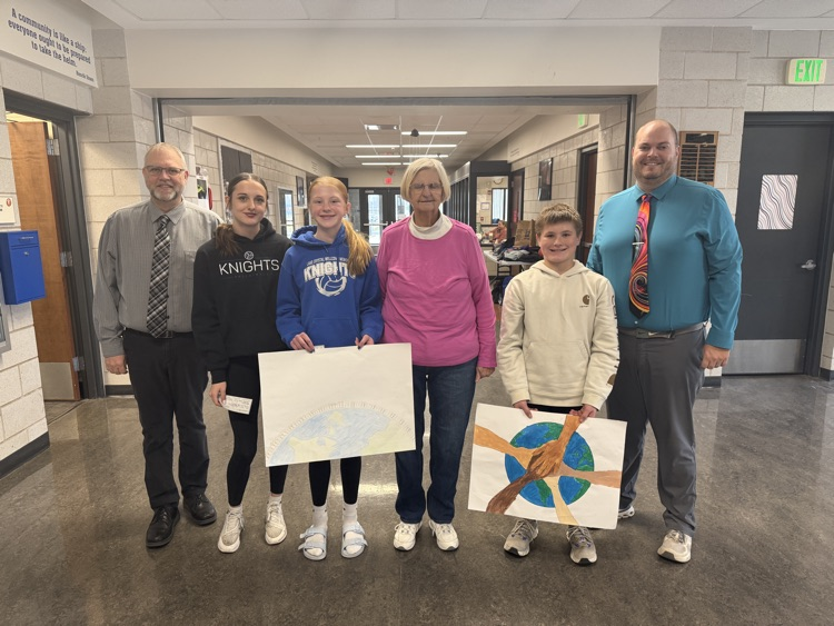 students posing with their peace posters  