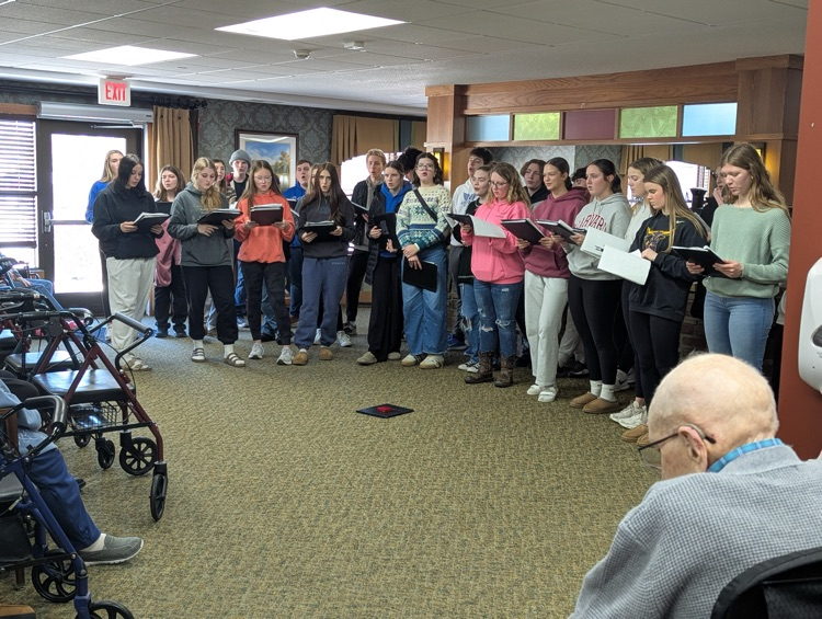 choir members singing at the nursing home in town  