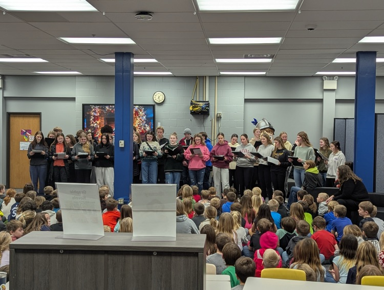 choir members singing at the elementary. 
